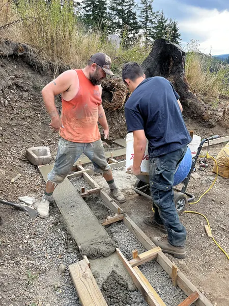 Finishing the concrete strip in its forms.